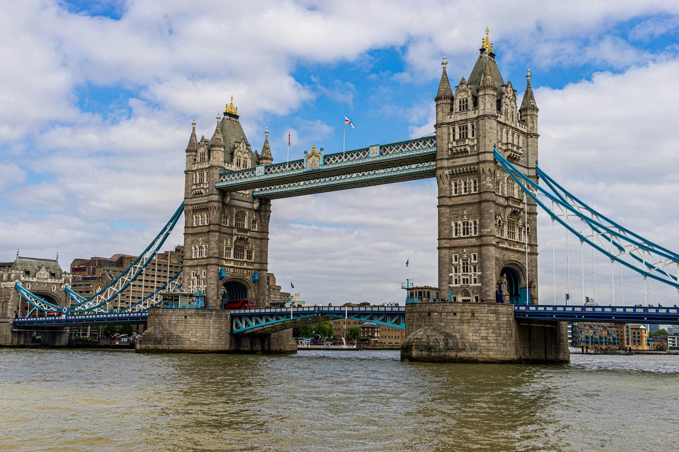 Tower Bridge over the River Thames under a partly cloudy sky