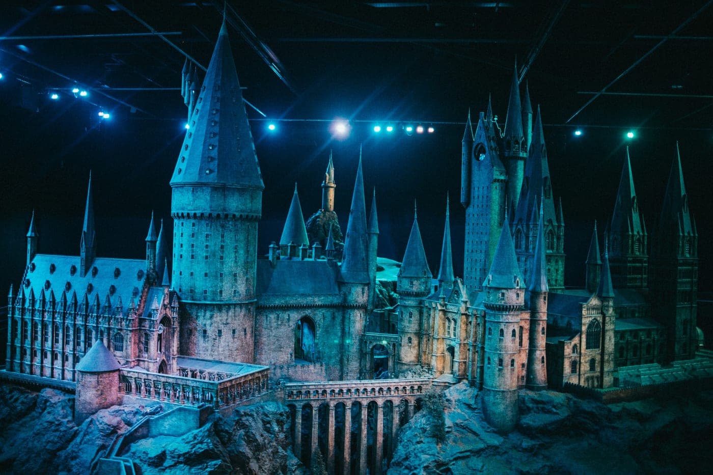 The Hogwarts castle model, lit in blue, at the Warner Bros. Studio Tour London